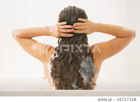 Young woman washing hair. rear view Young woman washing hair. rear view 16727106