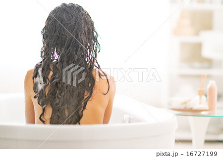 Young woman sitting in bathtub. rear view Young woman sitting in bathtub. rear view 16727199