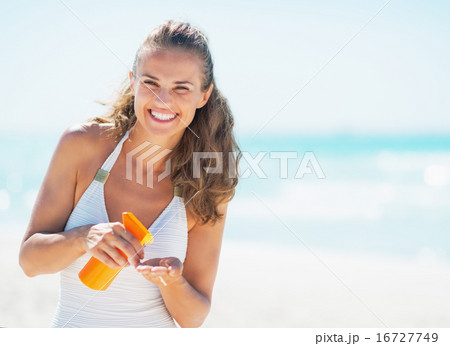 Portrait of smiling young woman with sun block creme Portrait of smiling young woman with sun block creme 16727749