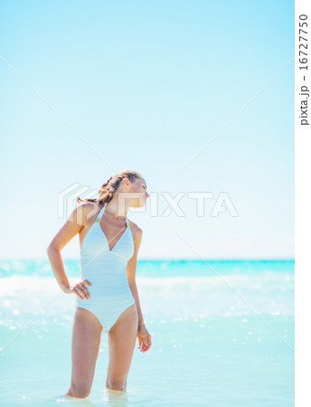 Portrait of relaxed young woman at seaside 16727750
