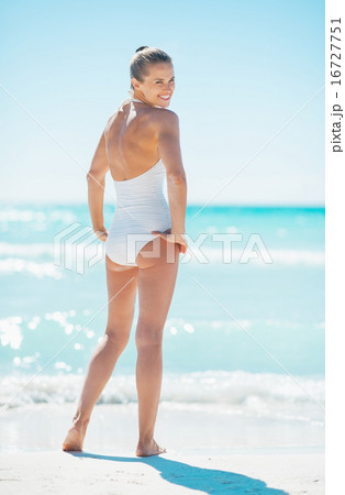 Full length portrait of young woman standing on beach 16727751