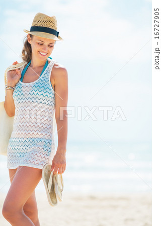Young woman in hat with bag on beach 16727905