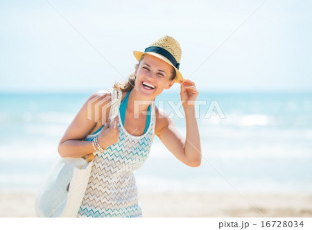 Happy young woman in hat on beach Happy young woman in hat on beach 16728034