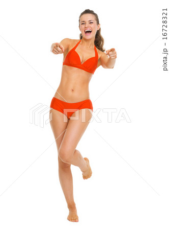 Full length portrait of smiling young woman in swimsuit pointing Full length portrait of smiling young woman in swimsuit pointing 16728321