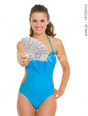 Smiling young woman in swimsuit showing fan of dollars Smiling young woman in swimsuit showing fan of dollars 16728322