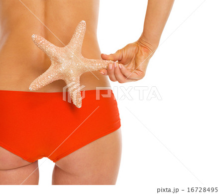 Closeup on starfish in hand of woman in swimsuit 16728495