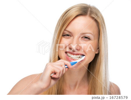 Smiling young woman brushing teeth Smiling young woman brushing teeth 16728579