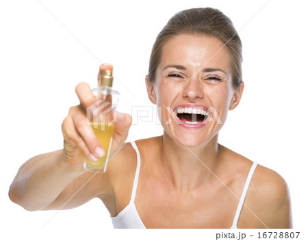 Happy young woman applying perfume in camera Happy young woman applying perfume in camera 16728807