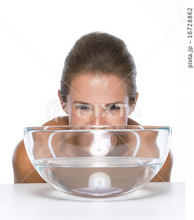 Happy young woman looking our from glass bowl with water 16728862