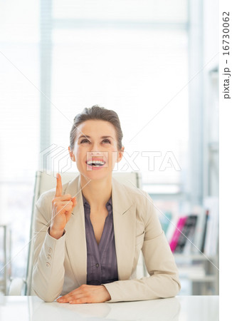 Happy business woman pointing on copy space 16730062