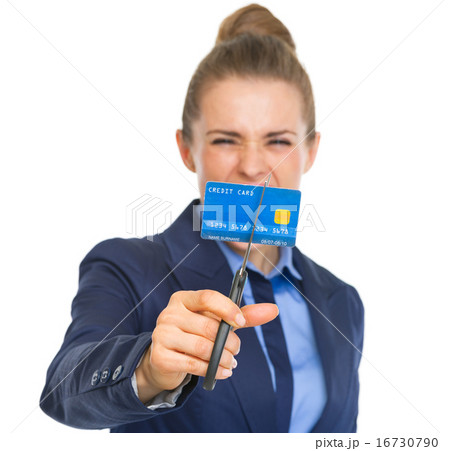 Closeup on angry business woman cutting credit card with scissor 16730790