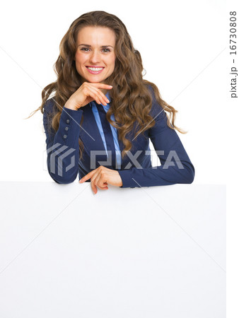 Smiling business woman showing blank billboard Smiling business woman showing blank billboard 16730808
