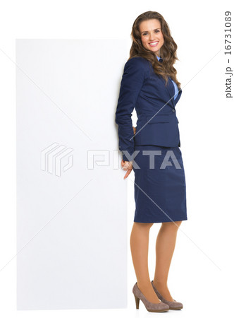 Full length portrait of happy business woman showing blank billb 16731089
