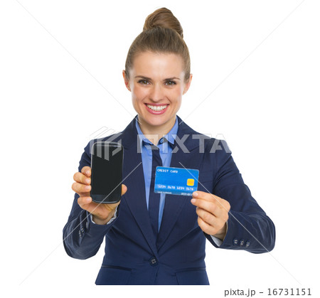 Happy business woman showing credit card and phone 16731151