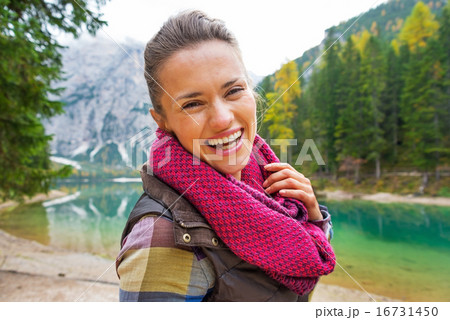 Portrait of happy young woman on lake braies in south tyrol, ita 16731450