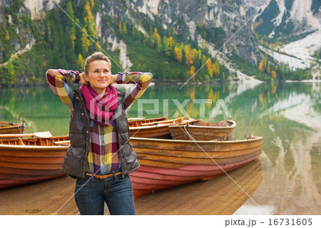 Portrait of relaxed young woman on lake braies in south tyrol, i 16731605