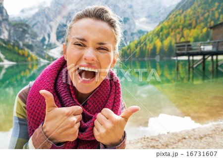 Portrait of happy young woman on lake braies in south tyrol, ita 16731607