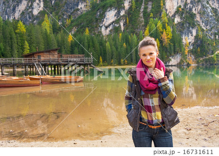 Portrait of happy young woman on lake braies in south tyrol, ita 16731611