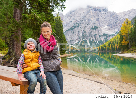 Portrait of happy mother and baby on lake braies in south tyrol, 16731614