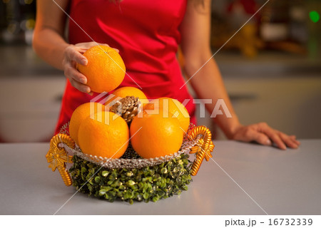 Closeup on young housewife taking orange Closeup on young housewife taking orange 16732339