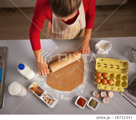 Young housewife rolling dough in kitchen Young housewife rolling dough in kitchen 16732341