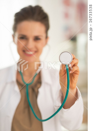 Closeup on doctor woman using stethoscope 16733538