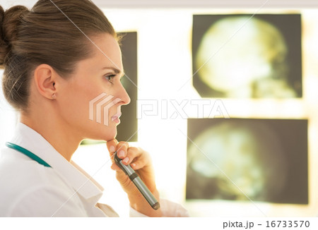 Portrait of doctor woman in front of lightbox 16733570