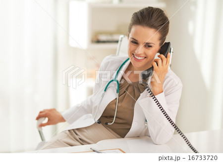 Happy doctor woman talking phone Happy doctor woman talking phone 16733720