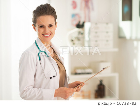 Portrait of doctor woman with clipboard in office 16733782