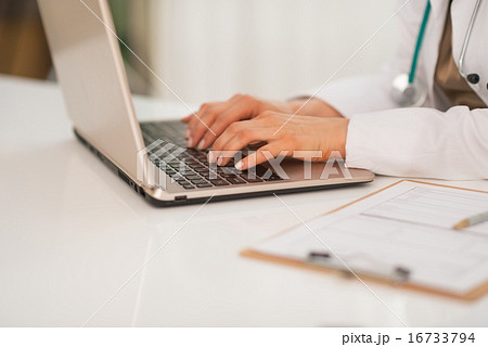 Closeup on medical doctor woman working on laptop 16733794