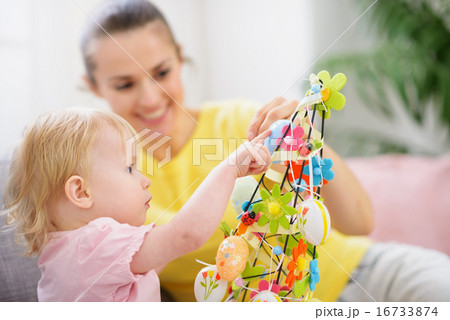 Mother helping baby made Easter decoration Mother helping baby made Easter decoration 16733874