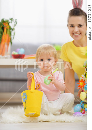 Baby playing with Easter decorations 16734018