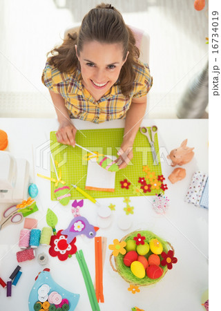 Young woman making easter decoration Young woman making easter decoration 16734019