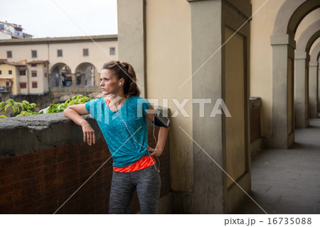 Fitness woman standing not far from ponte vecchio in florence, i Fitness woman standing not far from ponte vecchio in florence, i 16735088