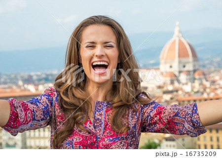 Happy young woman making selfie in front of panoramic view of fl 16735209