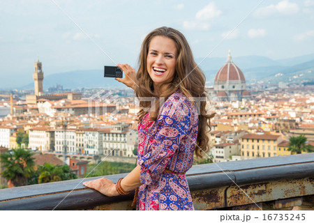 Happy young woman taking photo of panoramic view of florence, it Happy young woman taking photo of panoramic view of florence, it 16735245