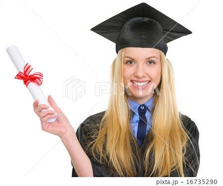 Smiling young woman in graduation gown holding diploma 16735290