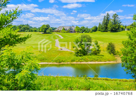 Golf place with pond and custom built luxury big house on background. Golf place with pond and custom built luxury big house on background. 16740768