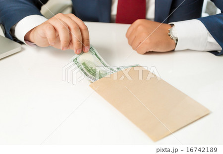businessman pulling banknote out of envelope  16742189