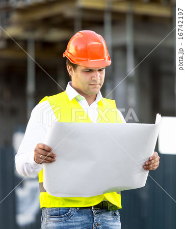 foreman reading blueprints against scaffolding foreman reading blueprints against scaffolding 16742197