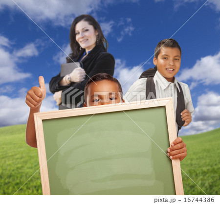 Hispanic Boy In Grass Holding Blank Chalk Board Hispanic Boy In Grass Holding Blank Chalk Board 16744386