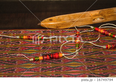 Spool of thread and wooden bobbin  16749794