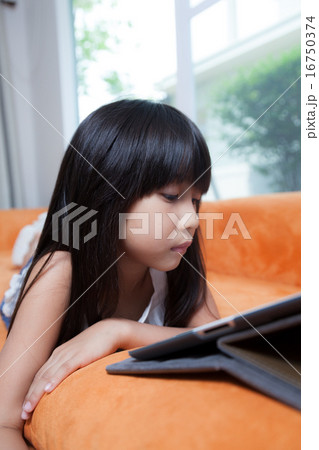 Girl playing with tablet. 16750374