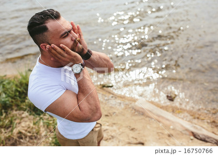 American Bearded Man touching his beard 16750766