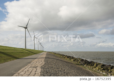 Modern windmills nearby the dike in Netherlands 16752395