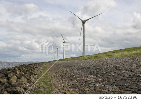 Modern windmills nearby the dike in Netherlands 16752396