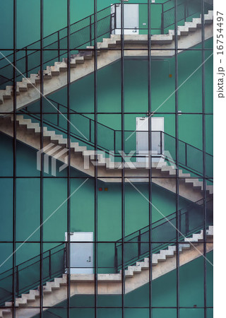 Stair flights outside a building with blue wall 16754497