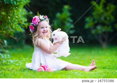 Cute girl playing with real bunny 16755386