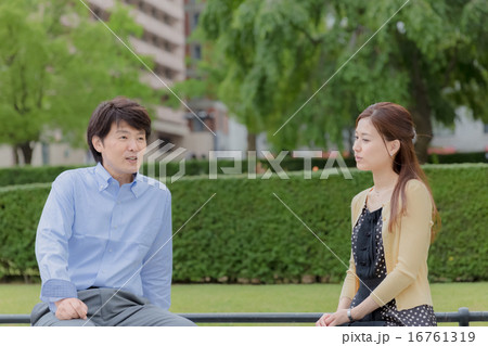 公園のベンチで話すカップル 公園のベンチで話すカップル 16761319