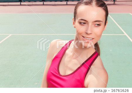 Pleasant girl staying on tennis court Pleasant girl staying on tennis court 16761626